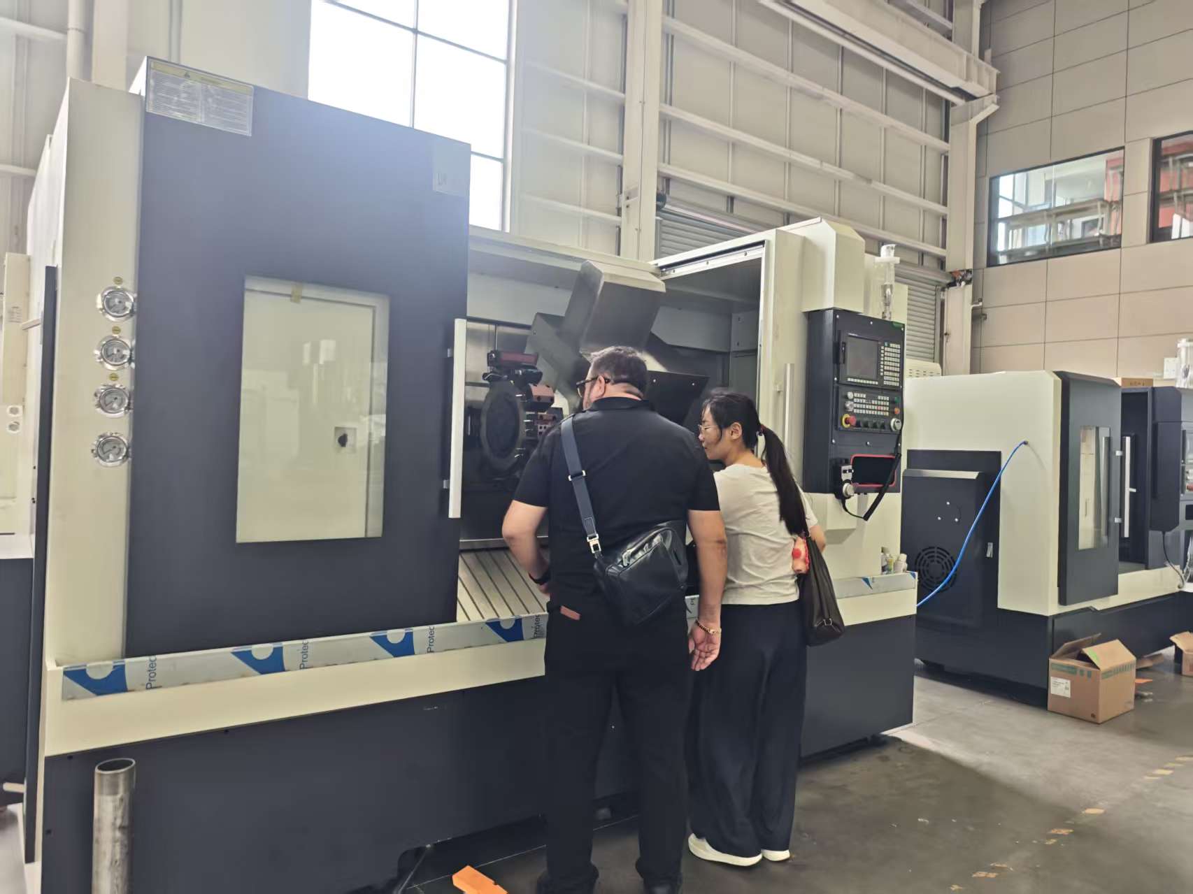 Inspecting the FCK 56Y-1000 CNC lathe in the workshop