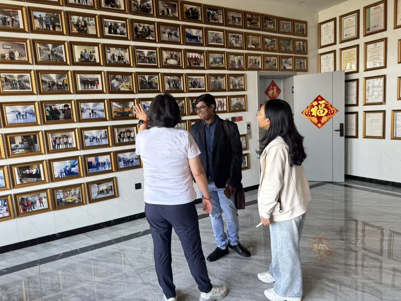 Mr. Shanu viewing the company history photo wall
