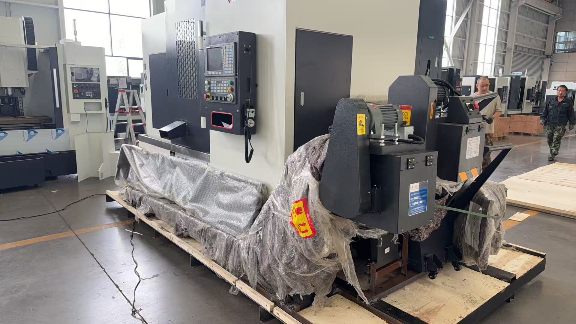 Side view showing the chip conveyor and protection wrapping